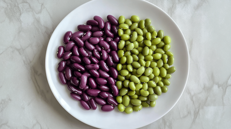 Raw and cooked purple beans side by side on a white plate.
