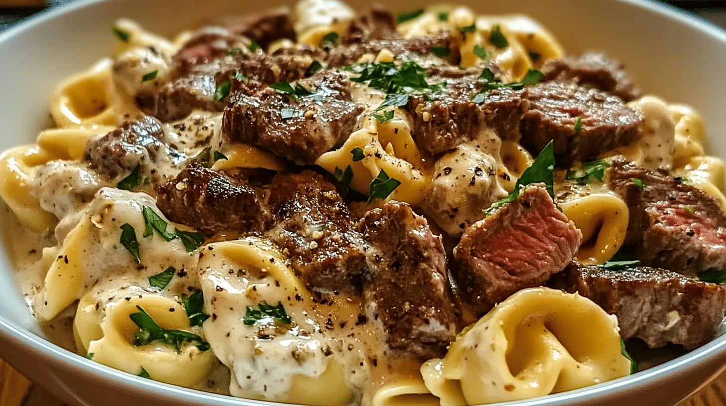 "A bowl of Cheesesteak Tortellini with creamy provolone sauce."