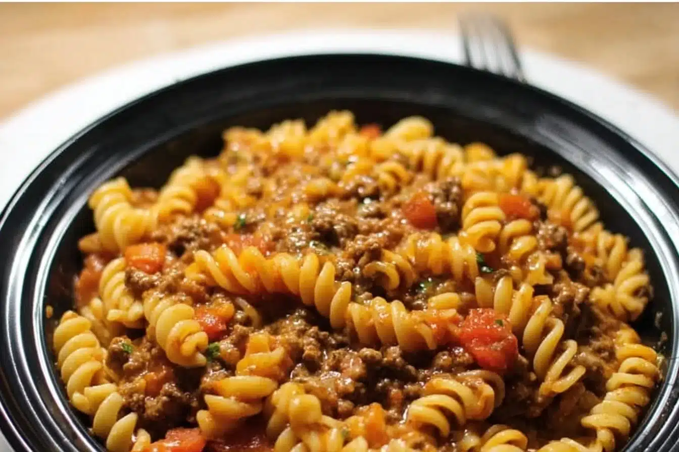 Crockpot Taco Pasta dish in a bowl with fresh toppings