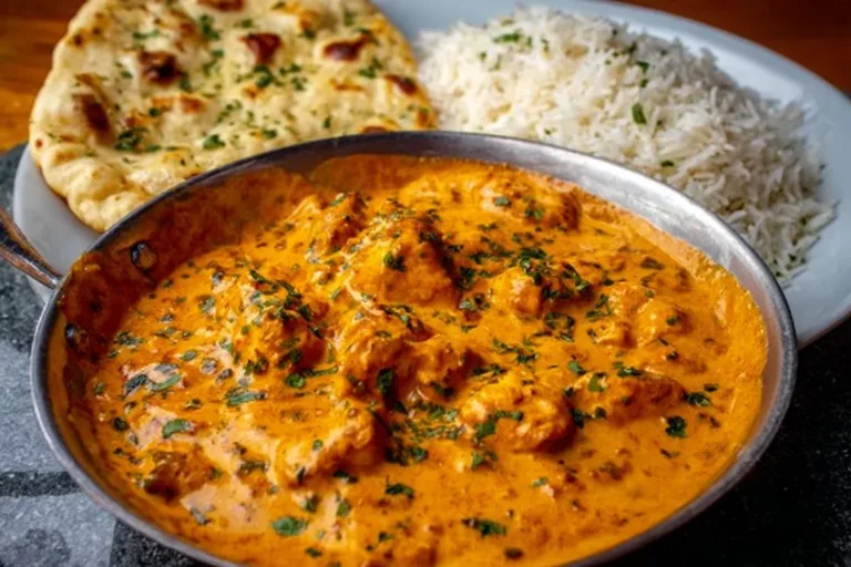 Delicious homemade butter chicken served with rice and naan bread