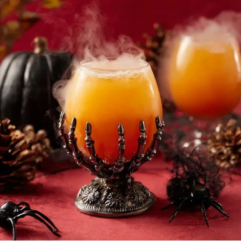 A spooky Witches Brew Punch in a cauldron with floating fruit and eerie colors.