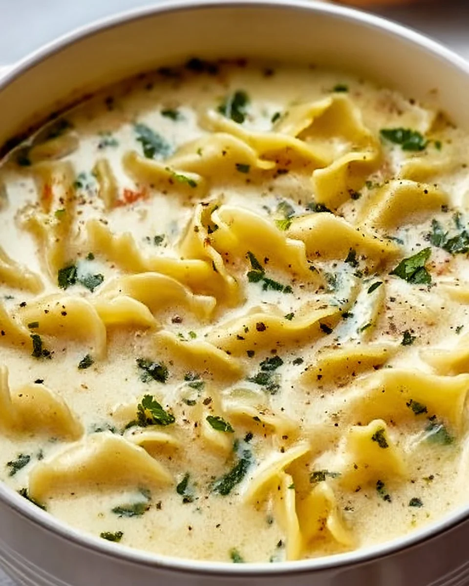 Delicious bowl of creamy white lasagna soup topped with cheese and herbs