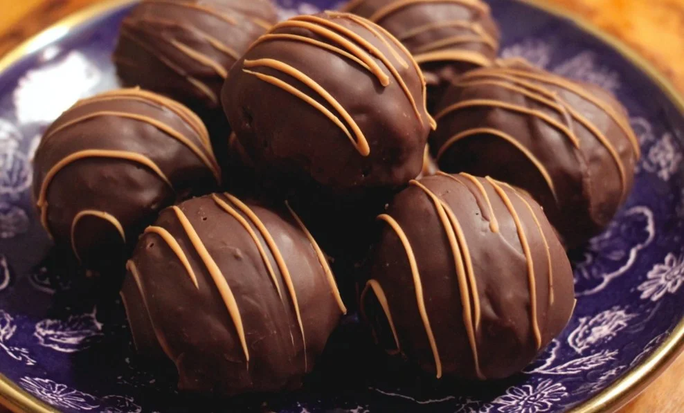 Delicious chocolate covered peanut butter balls presented on a plate