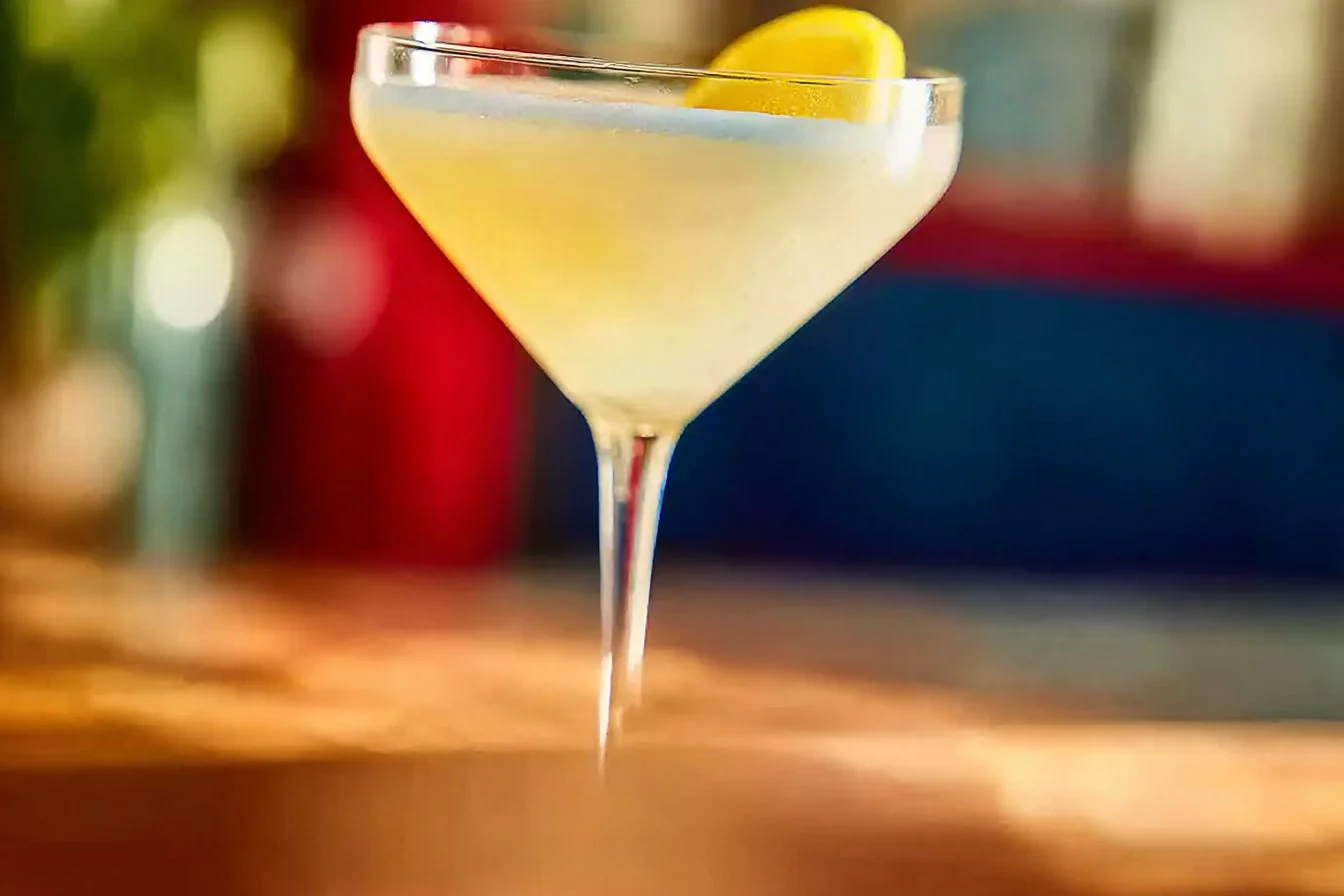 A refreshing Limoncello Martini garnished with a lemon twist, served chilled.