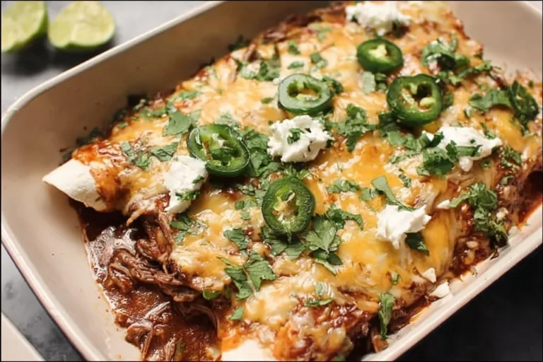 Delicious shredded beef enchiladas topped with enchilada sauce and cheese