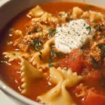 Bowl of delicious lasagna soup topped with cheese and fresh herbs
