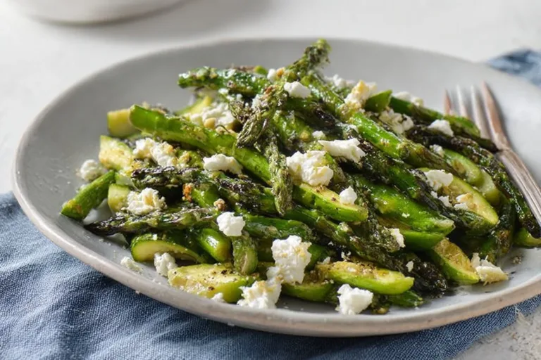 Grilled asparagus salad with lemon and feta on a plate