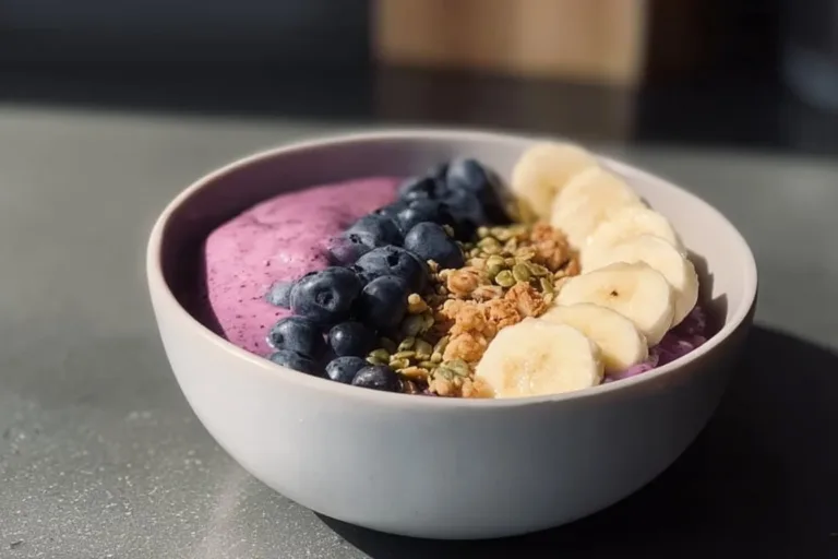 High protein breakfast smoothie bowl topped with fruits and seeds