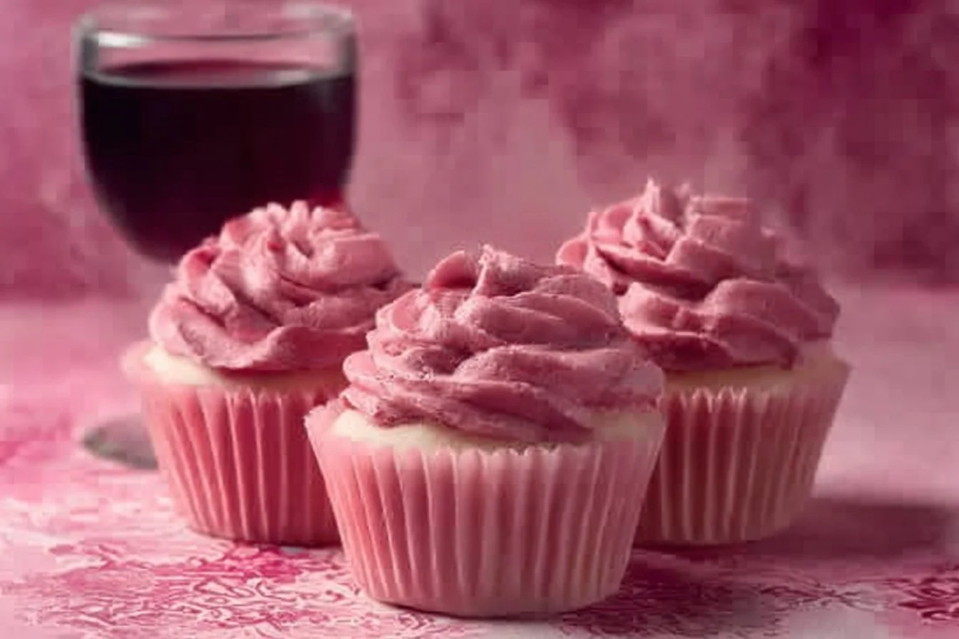 Delicious sangria cupcakes topped with fresh fruit and vibrant frosting.