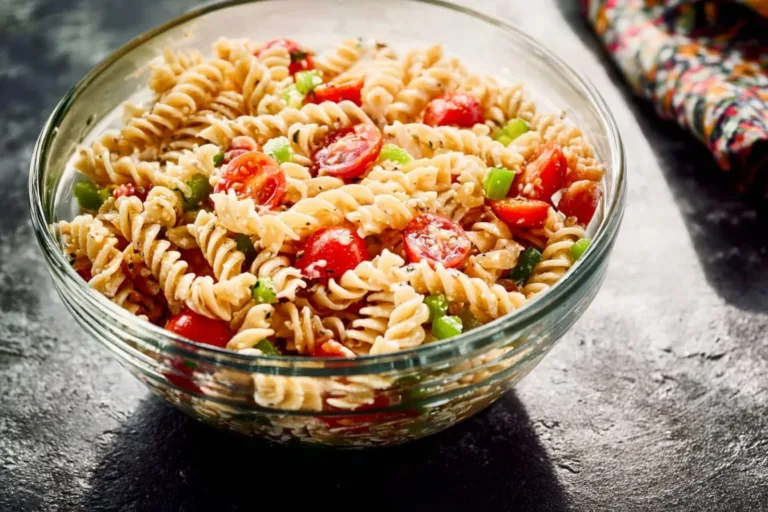 Delicious creamy pasta salad served in a bowl with fresh vegetables