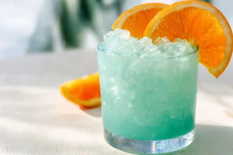 Blue Hawaiian Mocktail with tropical garnishes in a decorative glass