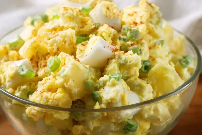 Bowl of grandma's classic potato salad with herbs and vegetables
