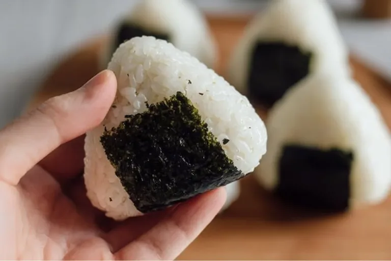 Tuna rice ball served on a plate with fresh green garnish