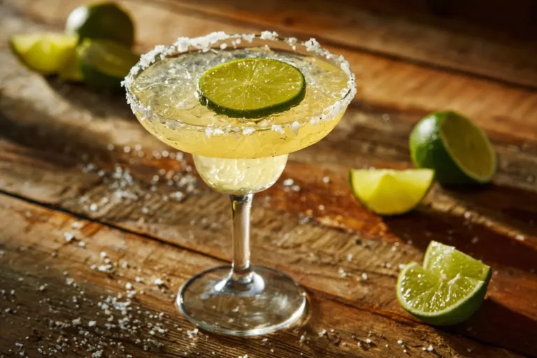 Classic Margarita cocktail with lime and salt rim in a glass