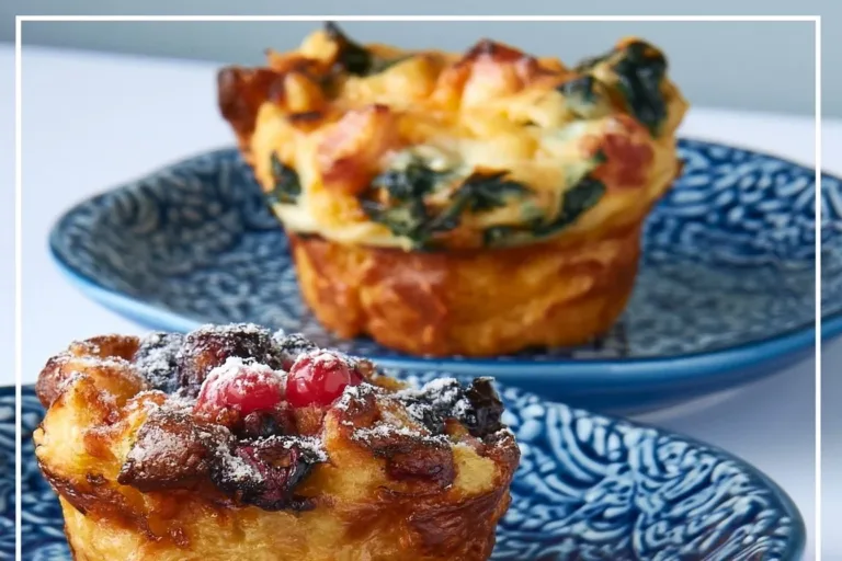 Freshly baked brioche cups filled with cream and fruit on a wooden table