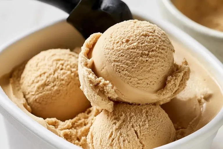 Delicious bowl of coffee ice cream topped with chocolate shavings and coffee beans