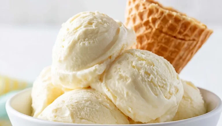 Delicious creamy pina colada ice cream topped with pineapple and coconut flakes