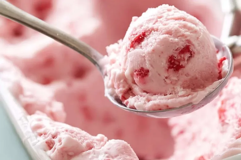 Delicious homemade strawberry ice cream served in a bowl with fresh strawberries