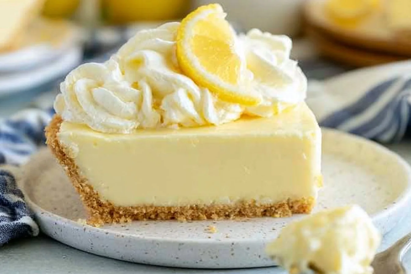 No-bake lemon cream pie topped with whipped cream and fresh lemon slices