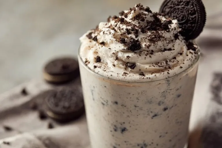 Oreo no-bake cheesecake cups with crushed Oreos and whipped cream topping