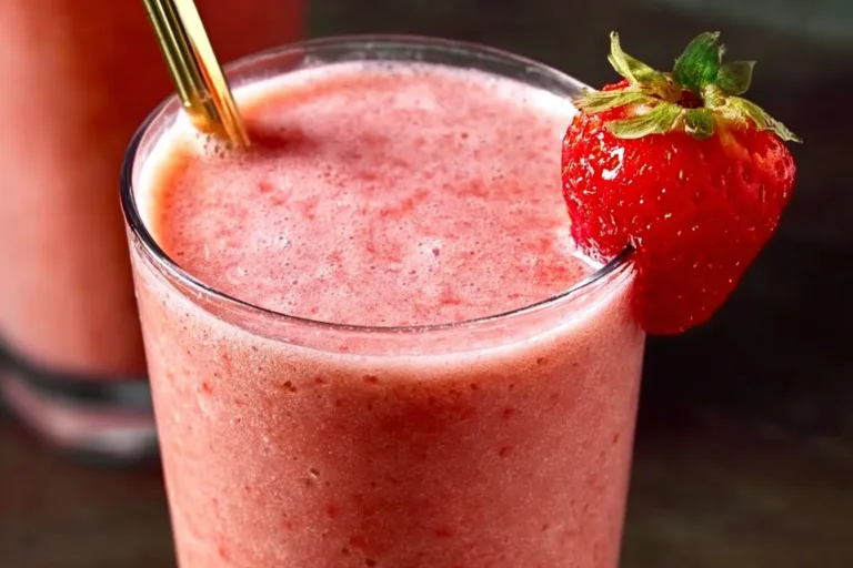 Strawberry pineapple smoothie in a glass with fresh fruits